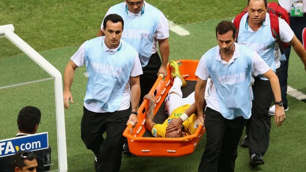 Brazil blow: Neymar is carried off on a stretcher.