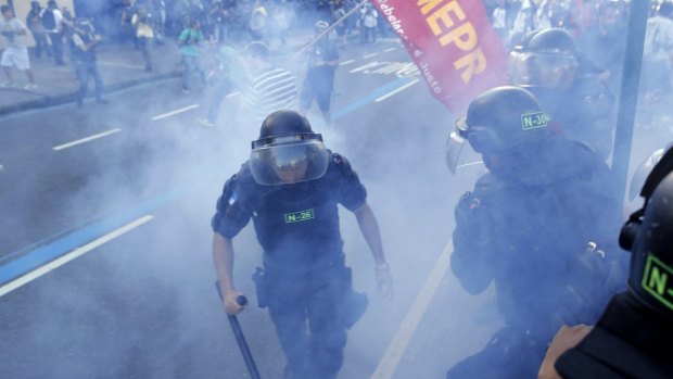 Police set off a smoke grenade during clashes with anti-World Cup protesters.