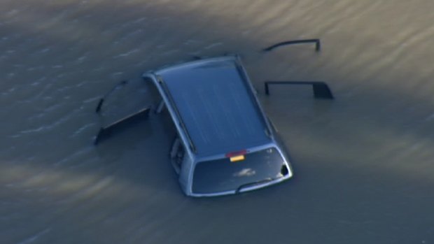 The car submerged in the lake.