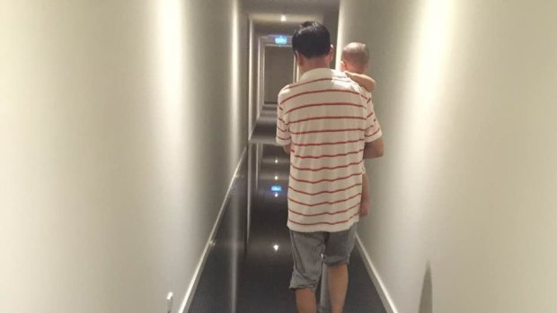 A man navigates through the corridor of a flooded apartment complex in Greensborough in December. 