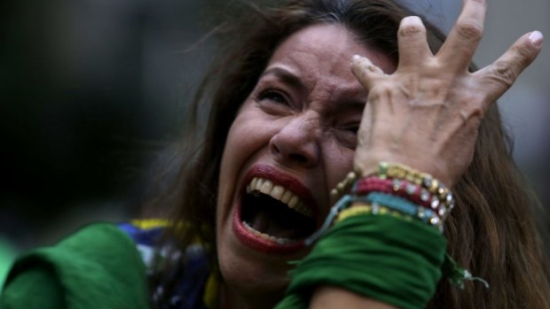Brazilians devastation: a fan cries as she watches her team being destroyed by Germany.