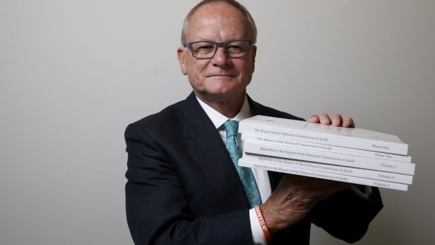 Commission of Audit author Tony Shepherd uses a Giants wristband to help him lift his findings.