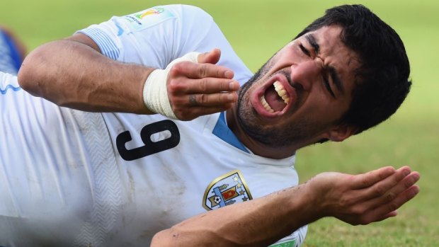 Facing a lengthy ban: Luis Suarez caught biting an opponent for the third time.