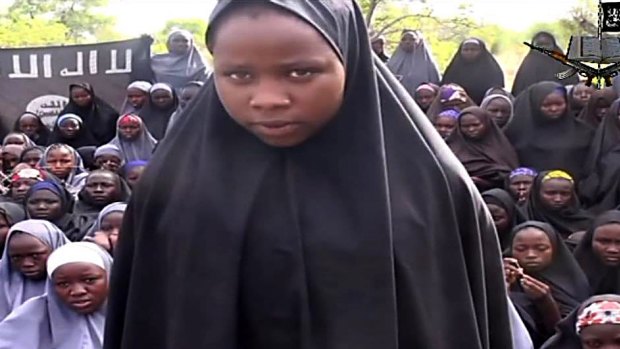 A girl, wearing a full-length hijab appears in a video at an undisclosed rural location, after more than 200 schoolgirls were kidnapped by Boko Haram in May 2014.