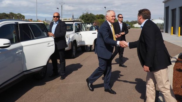Prime Minister Malcolm Turnbull shakes hands with Federal Member for O'Conner Rick Wilson after arriving at the Fire and Emergency Services building in Esperance.