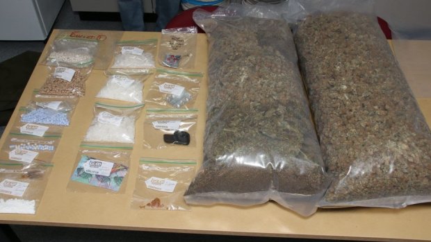 Police say a raid at a Townsville house turned up 12.5 kilograms of cannabis, 687 grams of ice, 2180 ecstasy pills, 28 grams of cocaine and 747 LSD tablets.
