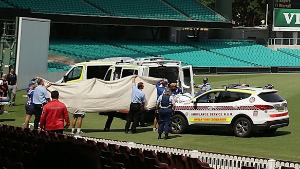 Paramedics treat Phillip Hughes at the Sydney Cricket Ground on Tuesday.