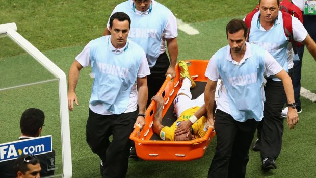 Brazil blow: Neymar is carried off on a stretcher.
