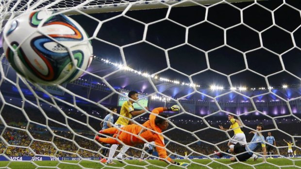Uruguay's goalkeeper Fernando Muslera can't keep Colombia's James Rodriguez out during their round of 16 match at the Maracana stadium in Rio de Janeiro.