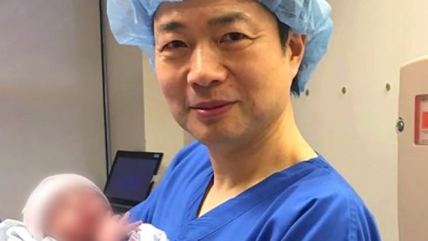 Dr John Zhang with the child who has three genetic parents.