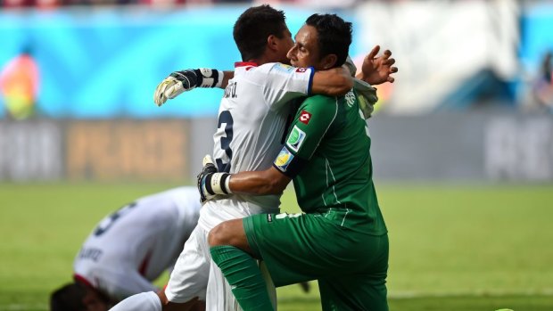 Oscar Granados and Keylor Navas of Costa Rica celebrate after defeating Italy.