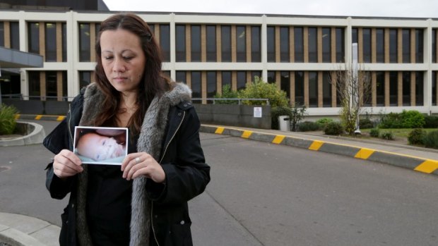 Eugenia Sequeira-Leo with a photograph of her new son Levi.