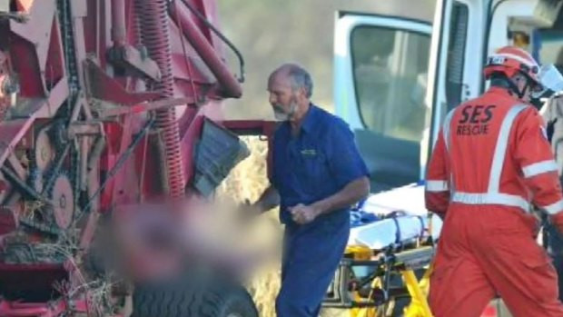 Rescuers work to free a man trapped in a hay baler at Mount Duneed, near Geelong.