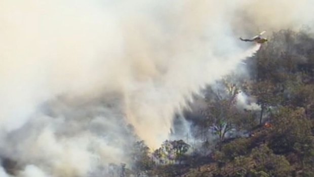A helicopter helps fight the fire in West Toodyay.