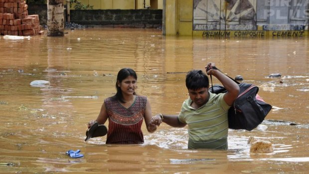 Heavy rains caused by strong monsoon: Residents wade through waist-deep water in Gauhati.