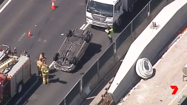 A car has flipped on its roof on the West Gate Freeway.