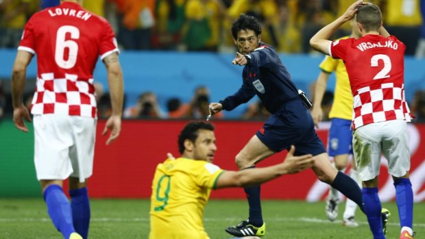 Big moment: referee Yuichi Nishimura of Japan awards Brazil a contentious penalty.