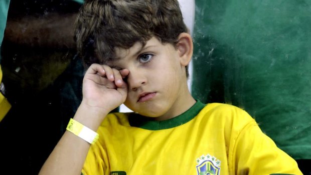 A young supporter watches Brazil getting thrashed by Germany.