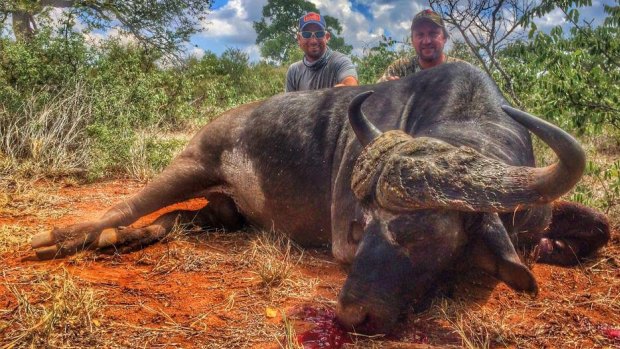 Corey Knowlton, left, poses after a hunting expedition. 