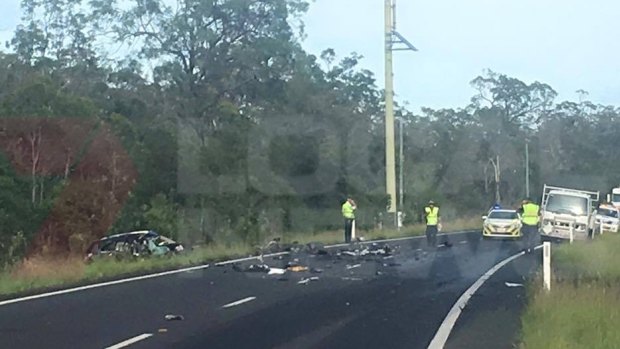 A woman has died after her car collided with a truck on the Bruce Highway.