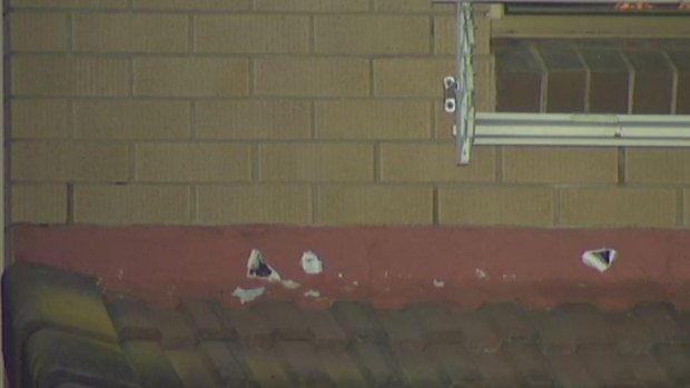 Bullet holes mark a Rochedale house after a shooting in the early hours of Tuesday.