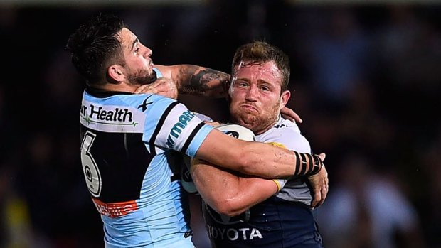 Monstered: Cowboys forward Gavin Cooper charges into Cronulla five-eighth Jack Bird.