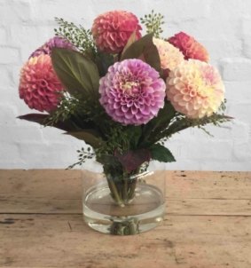 Water in the vase adds a touch of reality to these fake chrysanthemums. 