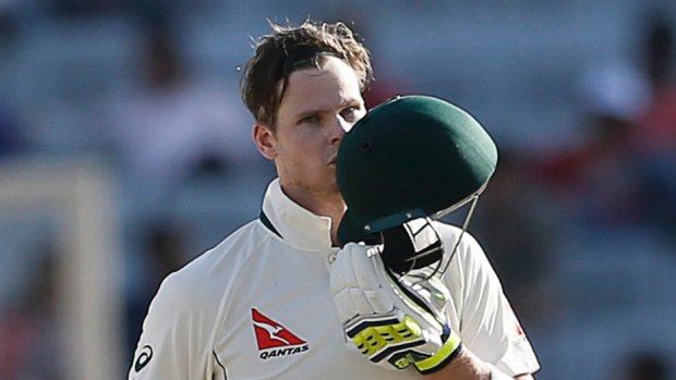 Captain Steven Smith kisses his helmet after scoring a century during the first day of the third Test.