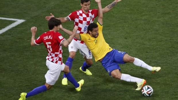 Brazil's Fred goes down under a challenge from Croatia's Dejan Lovren.