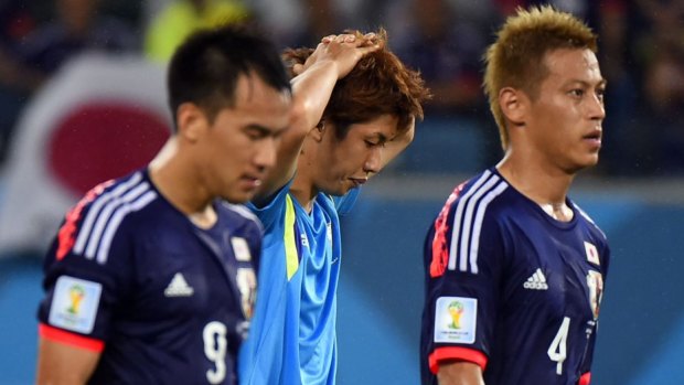 Disappointed ... Japan's forwards Shinji Okazaki, Yuya Osako and Keisuke Honda react at the end of a Group C match between Japan and Greece.