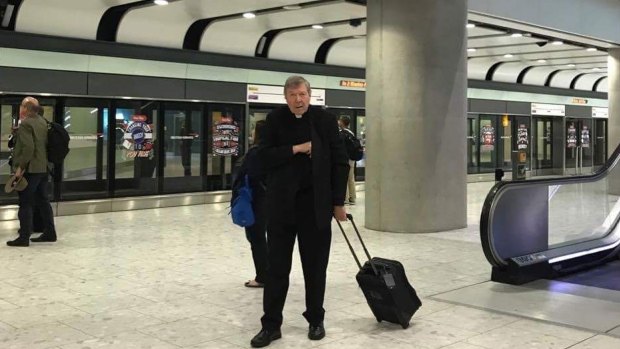 Cardinal George Pell at Heathrow on Friday after flying business class from Rome.