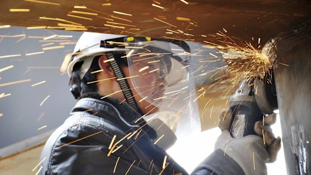 A labourer works inside a factory in Qingdao.