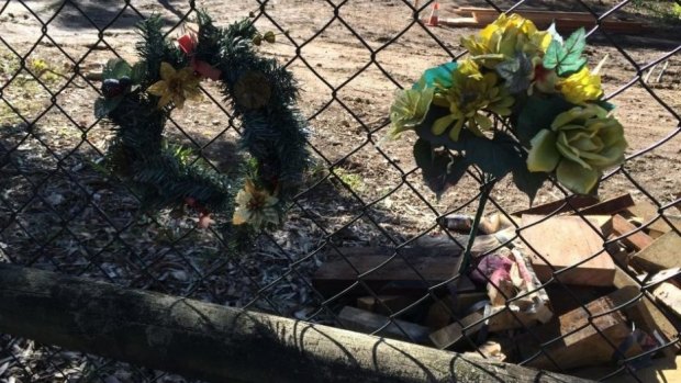 Wreaths on the fence of the Brookfield home where Allison Baden-Clay was allegedly murdered.