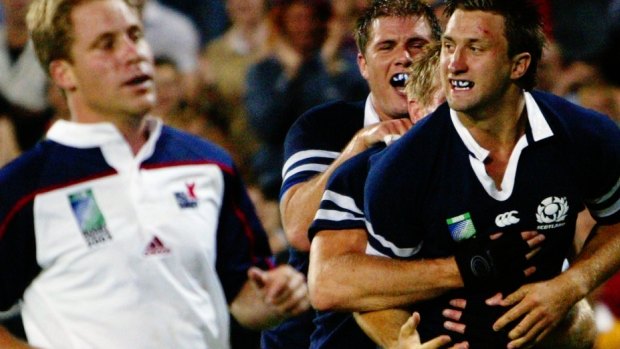 Simon Danielli (right) celebrates scoring a try for Scotland against the USA in Brisbane in 2003.