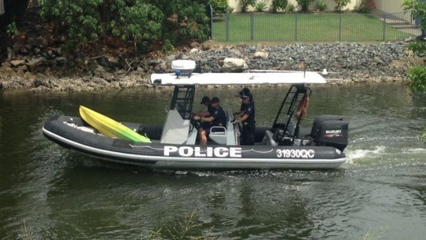 Gold Coast water police with a kayak found in the canal.