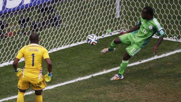 Victor Moses clears a shot off the line for Nigeria.