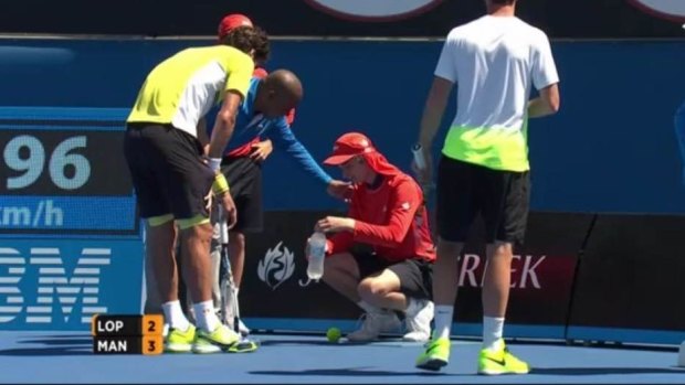 Painful blow: A ball boy receives treatment on Showcourt Three.
