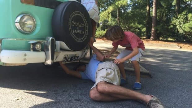 Catire Walker adjusts a valve under Fransisca the kombi van during a stop in North Carolina, part of the routine maintenance that kept the van moving since the family set off in Argentina in March. 