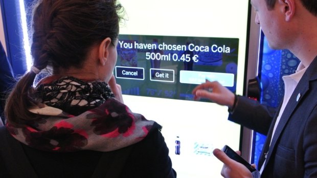 A demonstration of Coca-Cola's smart vending machines at the Mobile World Congress 2014 in Barcelona.