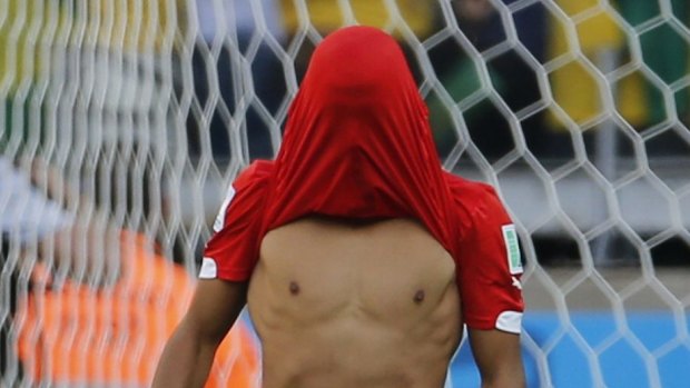Heartbreak: Chile's Alexis Sanchez reacts after his penalty shot was saved by Brazil's goalkeeper Julio Cesar.