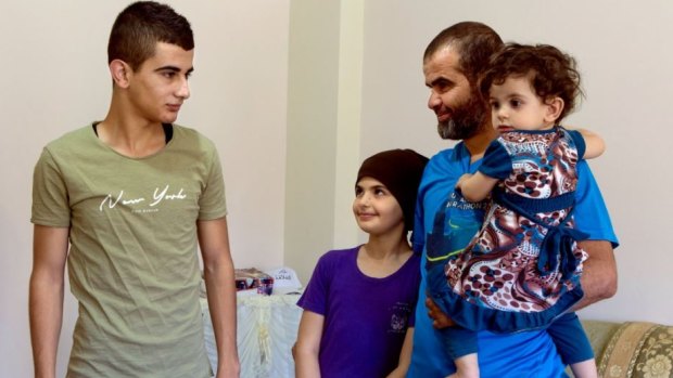 Othman Sabateen, 18, a Palestinian youth from Husan, at his home with his father and siblings. 