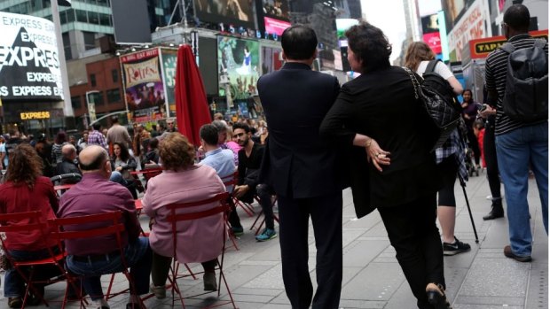 Kim Jong-un's maternal aunt and her husband walk around New York’s Times Square.