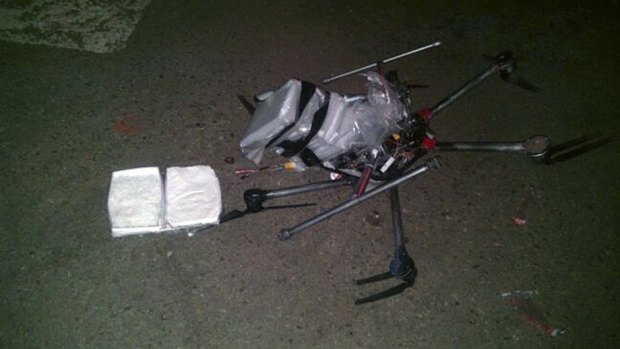 The drone loaded with packages containing methamphetamine lies on the ground after it crashed into a supermarket parking lot.