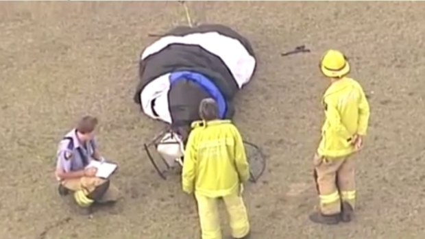 Paramedics are treating a man after he crashed what was believed to be a paramotor at Atkinsons Dam.