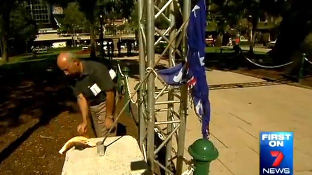 Peter Di Iorio sets fire to the Australian flag in Brisbane's Anzac Square just a day before Anzac Day.