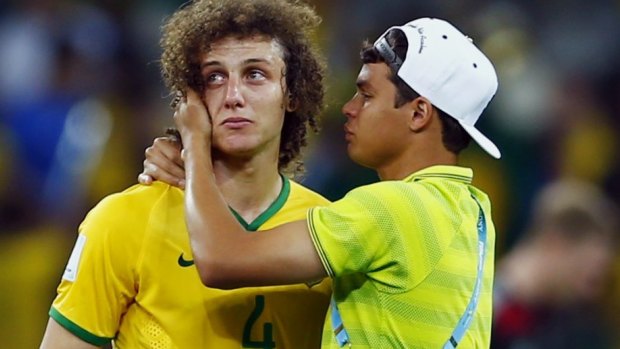 David Luiz is consoled by teammate Thiago Silva.