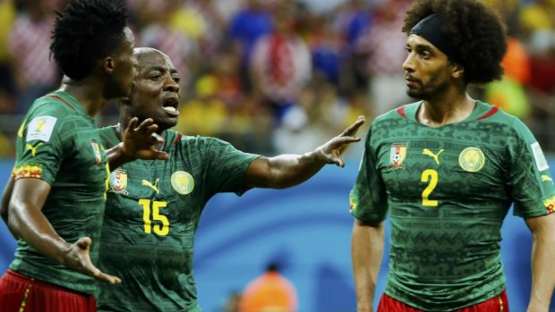 Cameroon's Achille Weboc tries to separate teammates Benjamin Moukandjo and Benoit Assou-Ekotto.