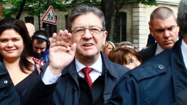 Far-left presidential candidate Jean-Luc Melenchon waves after voting in the first round of the French presidential election.