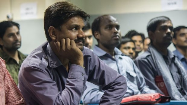 Auto-rickshaw drivers listen during a gender training session at Ashok Leyland Driver Training Institute in north Delhi.