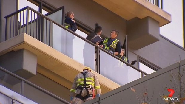 The woman fell from an apartment balcony on Queen Street just after 4pm.